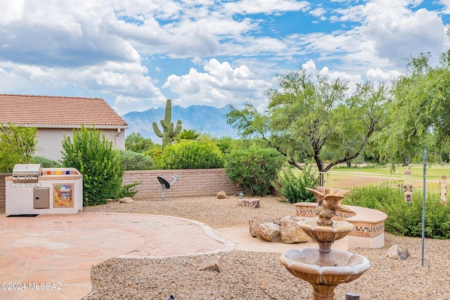 view of patio with a mountain view, area for grilling, and grilling area