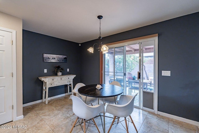 dining space with a notable chandelier