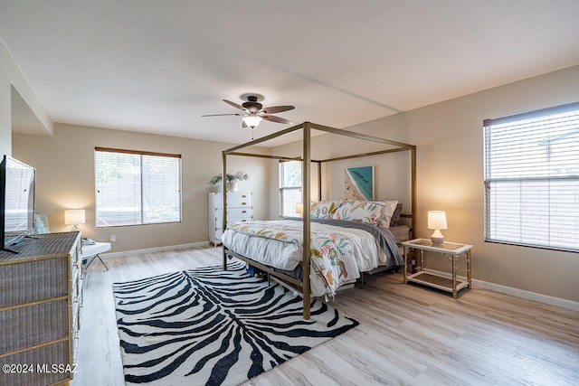 bedroom with ceiling fan and light hardwood / wood-style flooring