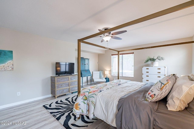 bedroom with light hardwood / wood-style floors and ceiling fan