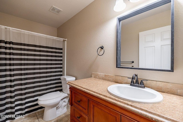 bathroom featuring tile patterned flooring, vanity, a shower with shower curtain, and toilet