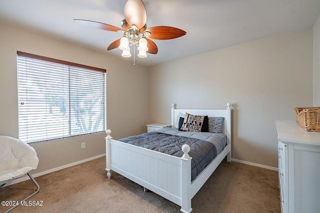 bedroom featuring multiple windows, ceiling fan, and carpet