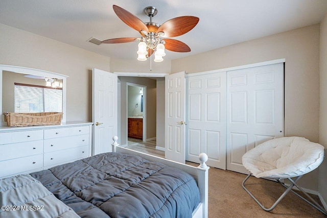 bedroom featuring ceiling fan, light carpet, and a closet