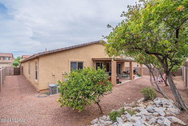 rear view of property with a patio area and cooling unit