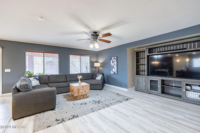 living room featuring light hardwood / wood-style floors and ceiling fan