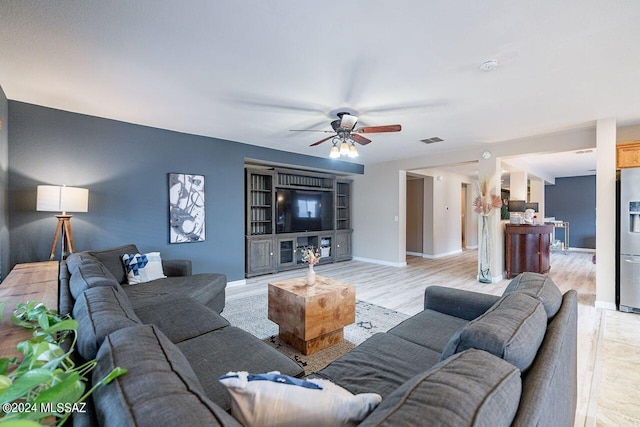 living room featuring light hardwood / wood-style floors and ceiling fan