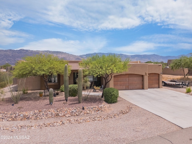 pueblo revival-style home with a mountain view and a garage