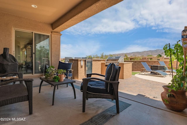 view of patio featuring a mountain view and area for grilling