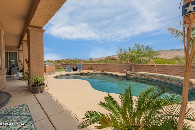 view of pool featuring a patio and a mountain view