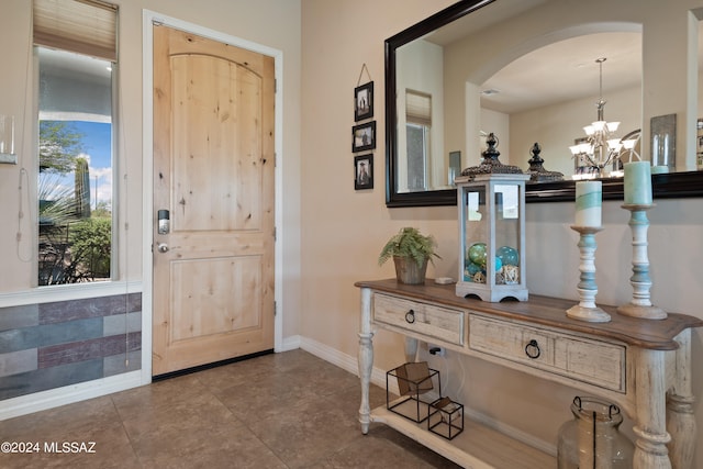 entrance foyer featuring a notable chandelier and tile patterned flooring