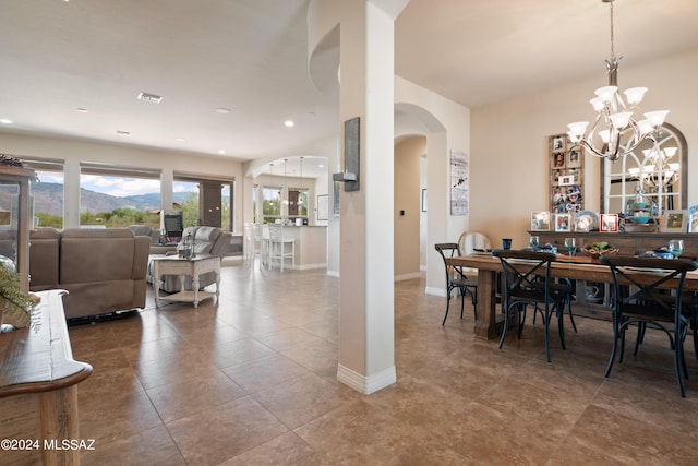 dining space with a chandelier and tile patterned floors