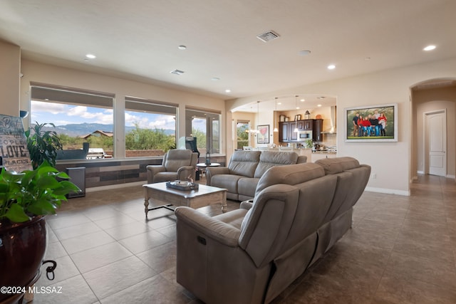 tiled living room featuring a mountain view