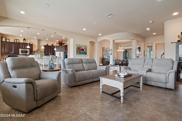 tiled living room featuring a chandelier