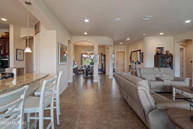 living room featuring an inviting chandelier and tile patterned floors