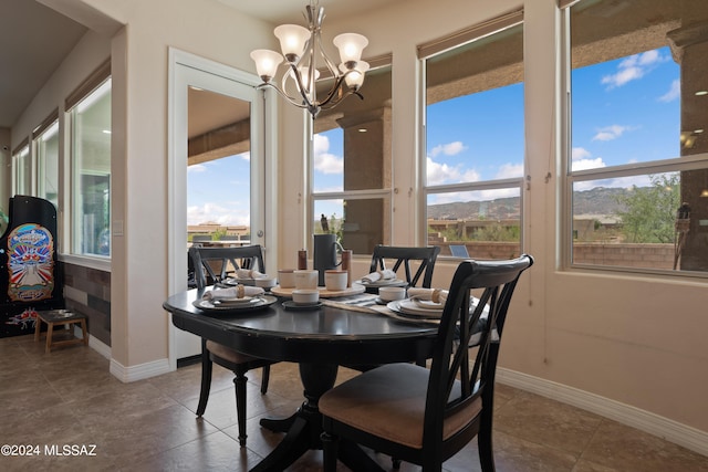 tiled dining space with an inviting chandelier and plenty of natural light