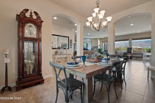 tiled dining area featuring a notable chandelier