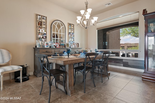 tiled dining area featuring a notable chandelier