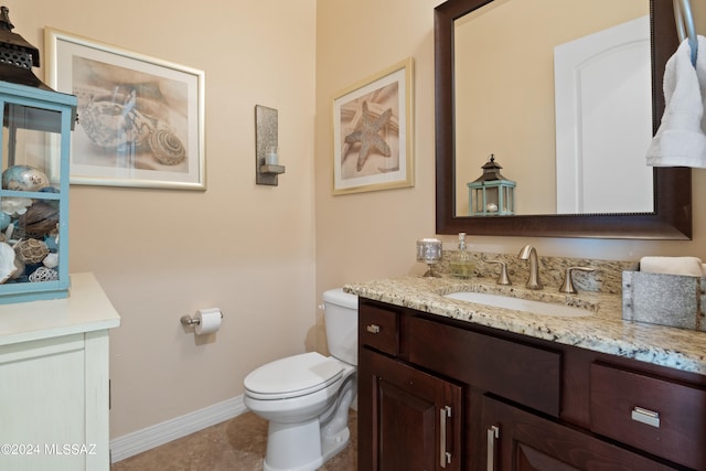 bathroom with vanity, toilet, and tile patterned floors