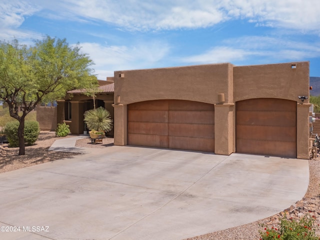 pueblo-style house with a garage