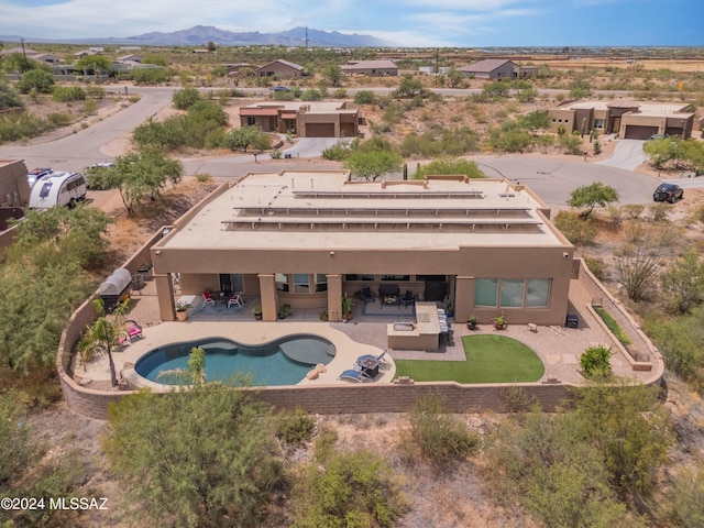 view of swimming pool featuring an outdoor living space, a mountain view, and a patio area