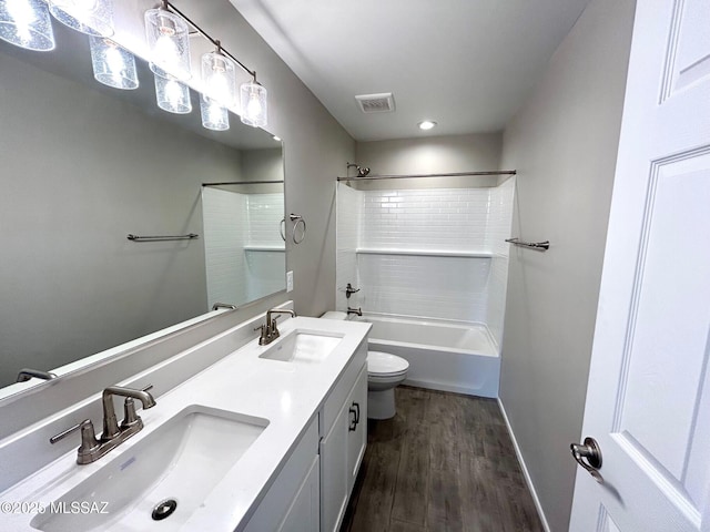 full bathroom featuring shower / washtub combination, toilet, hardwood / wood-style floors, and vanity