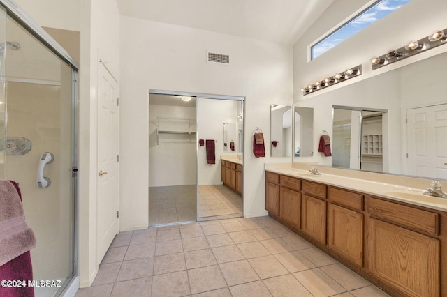 bathroom featuring tile patterned floors, vanity, and an enclosed shower