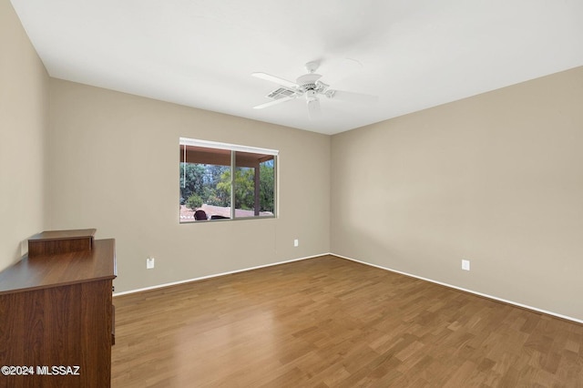 unfurnished room with ceiling fan and wood-type flooring