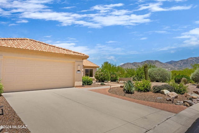 view of front facade with a mountain view and a garage