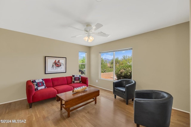 living room featuring light wood-type flooring and ceiling fan