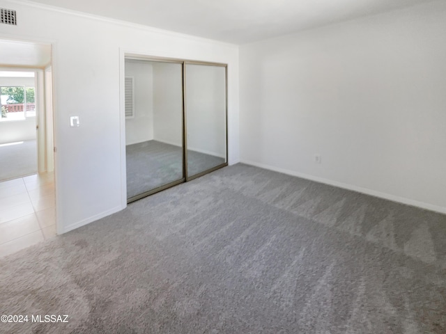 unfurnished bedroom featuring a closet and carpet