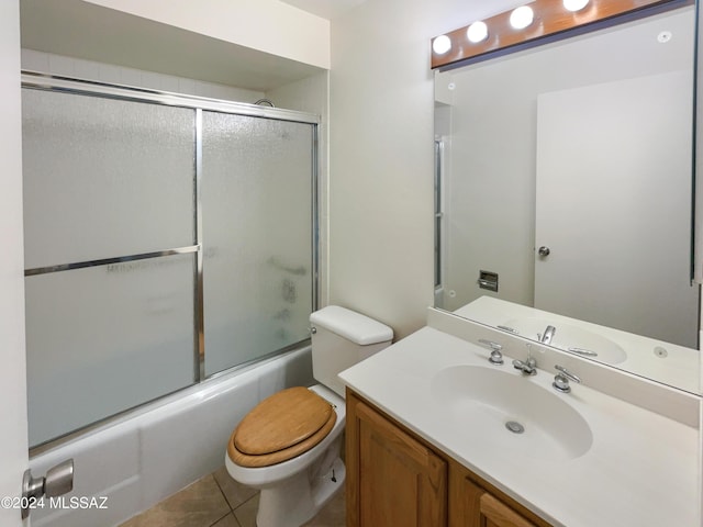 full bathroom with tile patterned flooring, vanity, enclosed tub / shower combo, and toilet