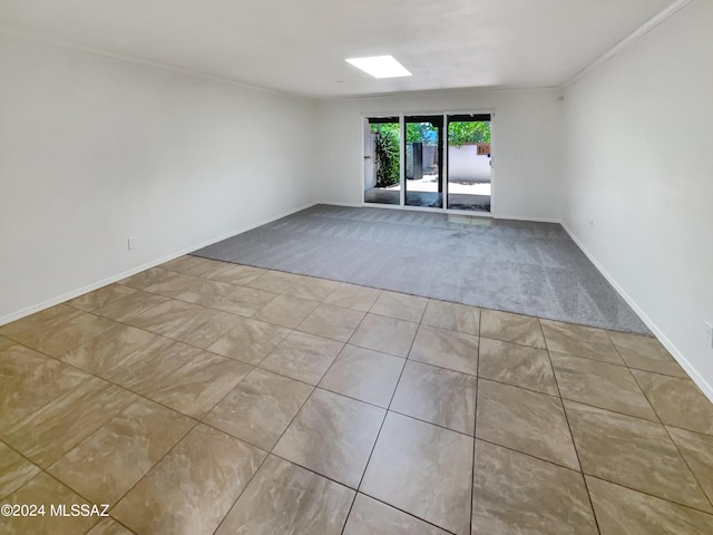 unfurnished room featuring light tile patterned floors and crown molding