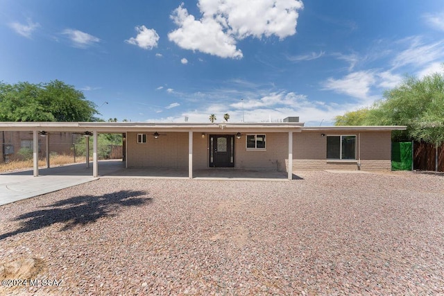 back of property featuring a carport