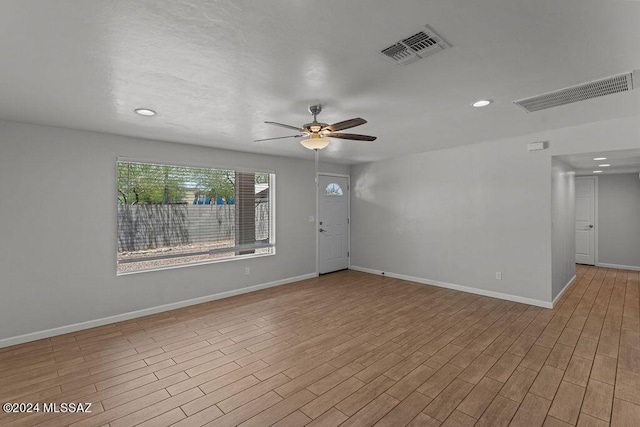 unfurnished room with light hardwood / wood-style flooring and ceiling fan