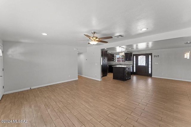 unfurnished living room with ceiling fan and light wood-type flooring