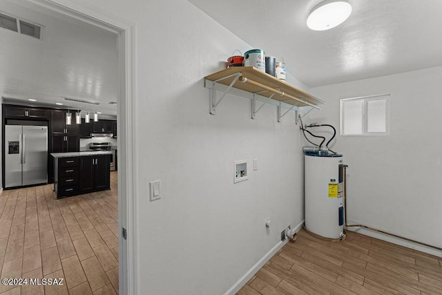 laundry room featuring light wood-type flooring, hookup for a washing machine, electric water heater, and hookup for a gas dryer