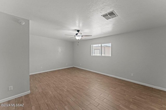 empty room featuring light wood-type flooring and ceiling fan