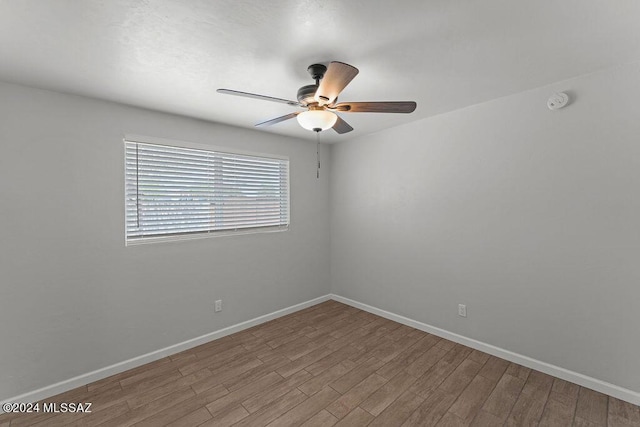 empty room with light hardwood / wood-style floors and ceiling fan