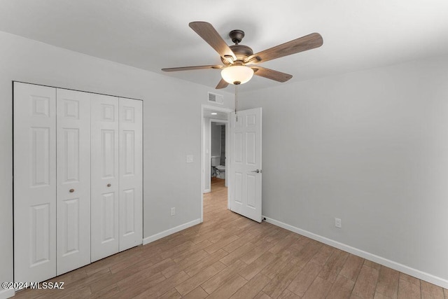 unfurnished bedroom with ceiling fan, a closet, and light hardwood / wood-style flooring