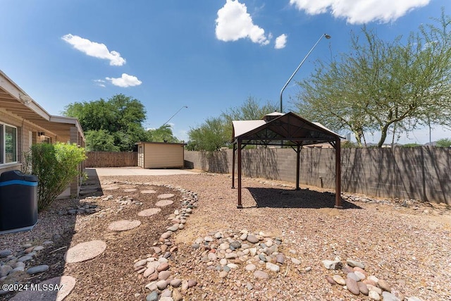 view of yard with a gazebo and a storage shed