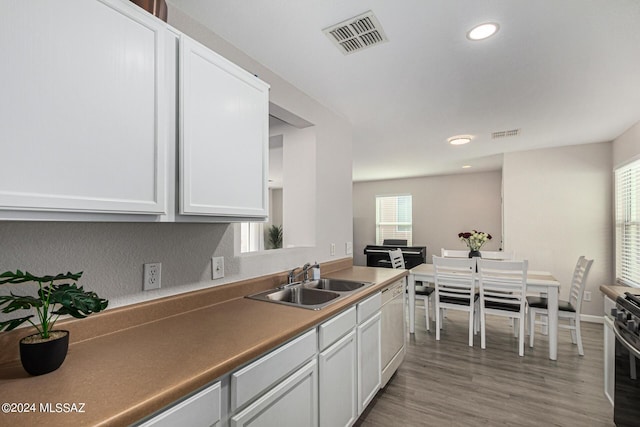 kitchen featuring sink, white cabinets, and light hardwood / wood-style flooring