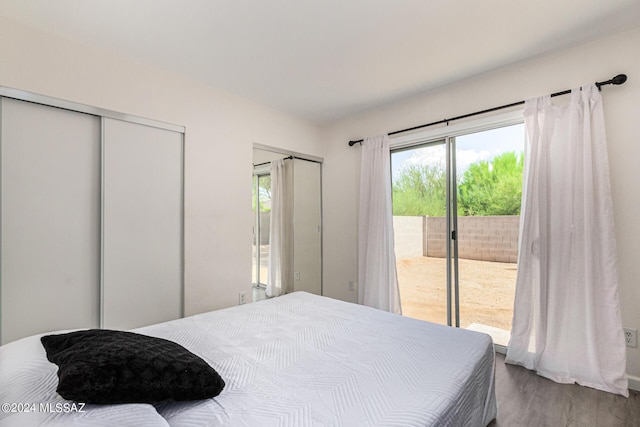 bedroom featuring hardwood / wood-style floors and access to outside