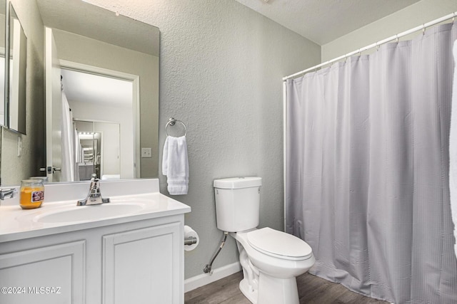 bathroom featuring vanity, hardwood / wood-style floors, and toilet