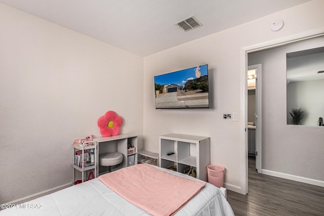 bedroom featuring dark hardwood / wood-style flooring