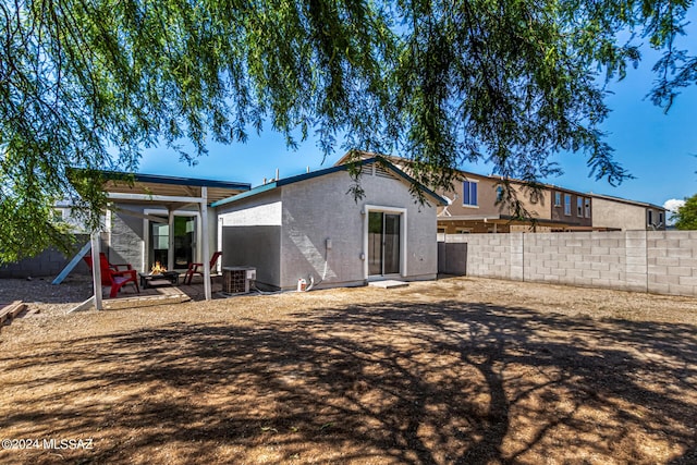 rear view of house featuring a patio and central AC