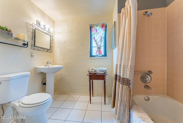 full bathroom featuring tile patterned flooring, toilet, sink, and shower / tub combo with curtain