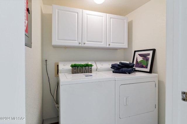 laundry room with washer and clothes dryer and cabinets