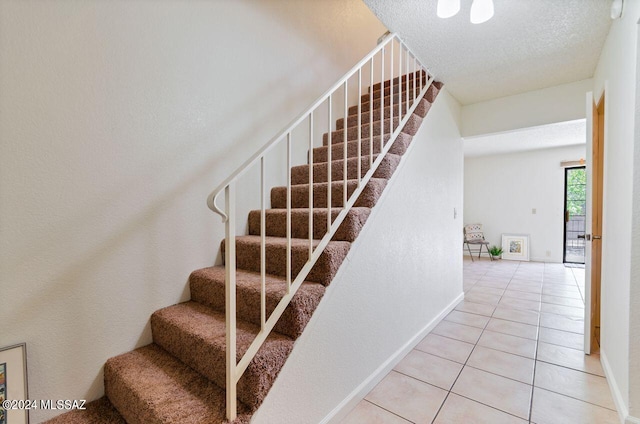 stairway with tile patterned floors