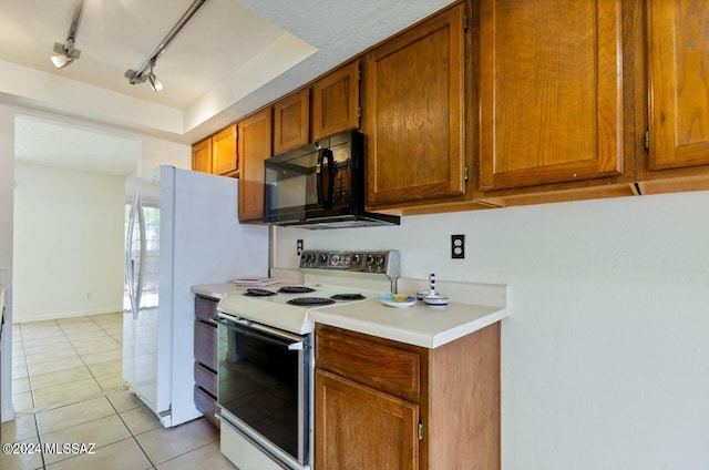 kitchen with light tile patterned flooring and white appliances