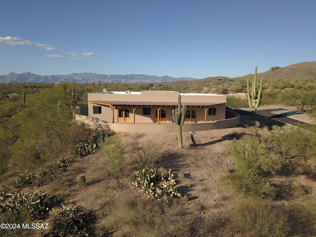 rear view of property featuring a mountain view